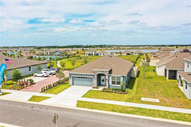 view of front of property featuring a front yard and a garage