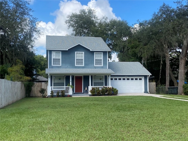 view of front of home with a porch, a garage, and a front lawn