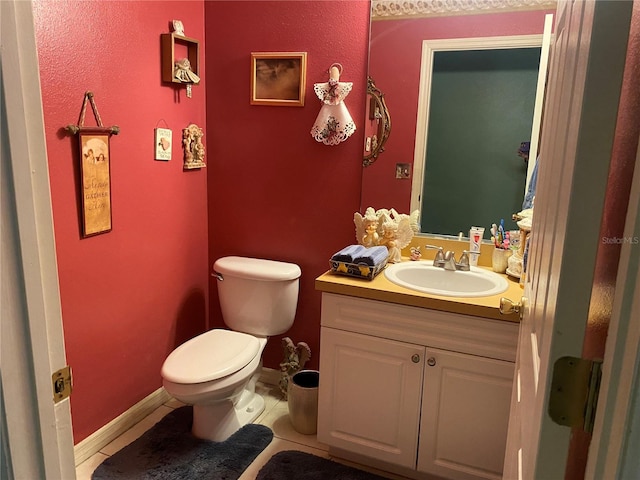 bathroom featuring toilet, vanity, and tile patterned floors