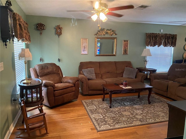 living room with ceiling fan and light hardwood / wood-style flooring