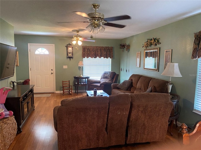 living room with ceiling fan and light hardwood / wood-style floors