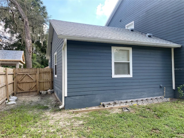 view of side of home with a lawn