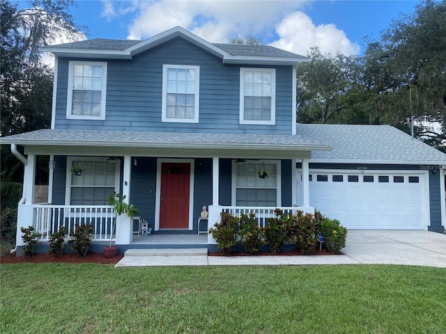 view of front property with a front yard, a garage, and covered porch