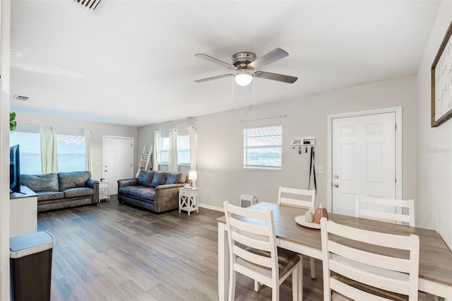 dining area with ceiling fan and hardwood / wood-style flooring