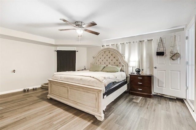 bedroom featuring light wood-type flooring and ceiling fan