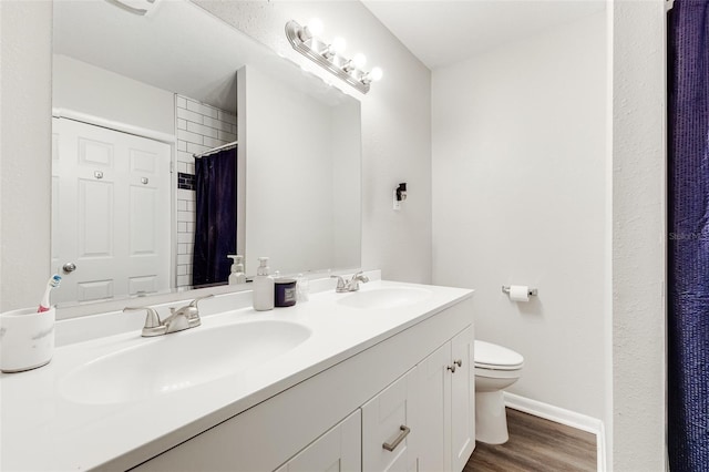 bathroom with walk in shower, vanity, toilet, and hardwood / wood-style flooring