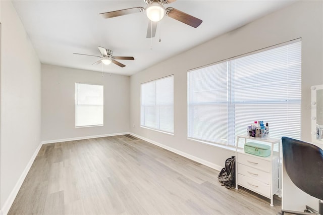 office space featuring ceiling fan and light wood-type flooring