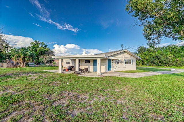 rear view of house with a patio area and a yard