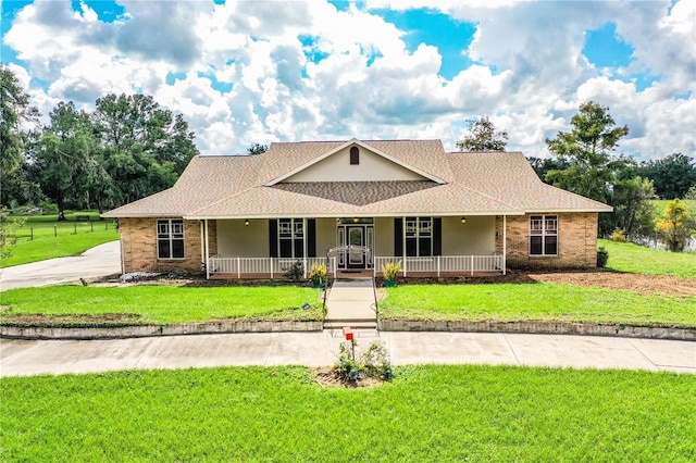 view of front facade with a front yard and covered porch