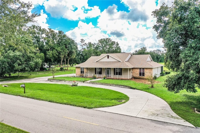 ranch-style home with a porch and a front lawn