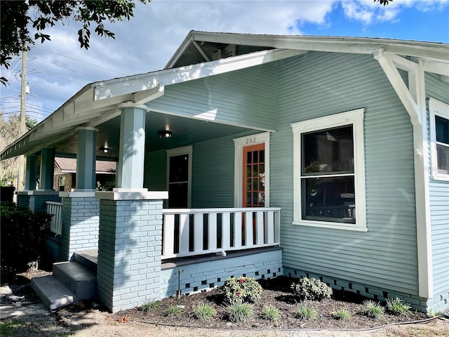 view of side of property featuring a porch