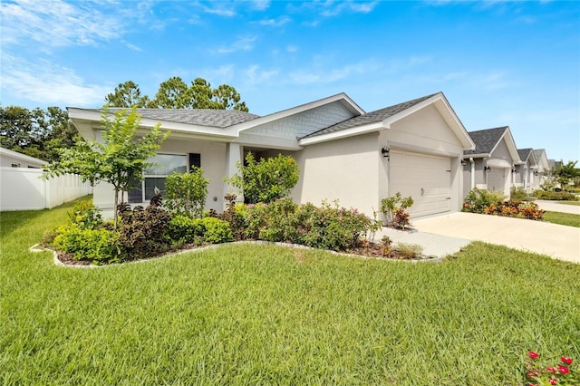 single story home with a garage and a front lawn