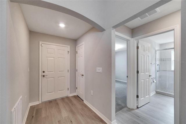 corridor with light wood-type flooring