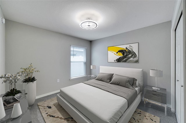 bedroom featuring a textured ceiling and a closet