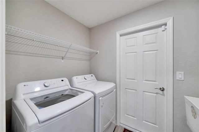 laundry area with separate washer and dryer