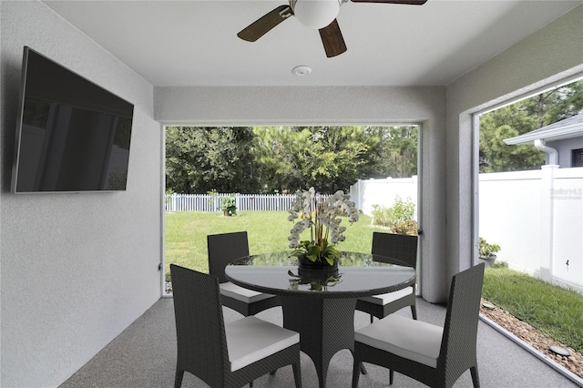 sunroom / solarium featuring ceiling fan