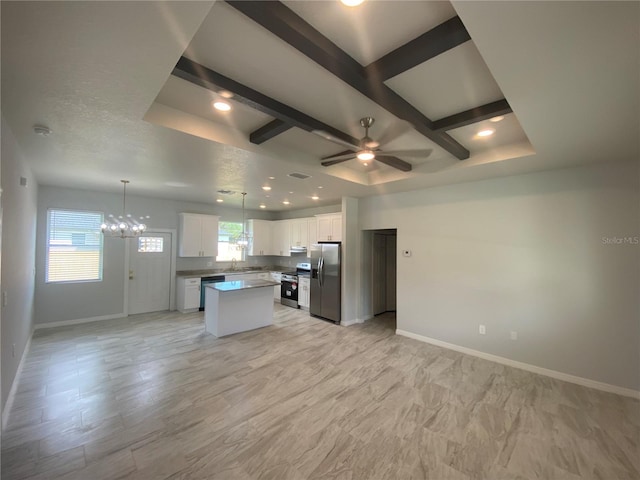 kitchen featuring white cabinets, beamed ceiling, pendant lighting, a kitchen island, and stainless steel appliances