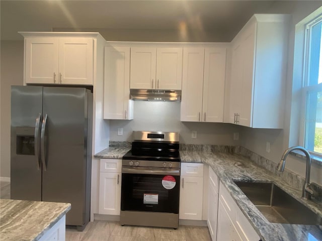 kitchen with white cabinets, sink, light stone countertops, and stainless steel appliances