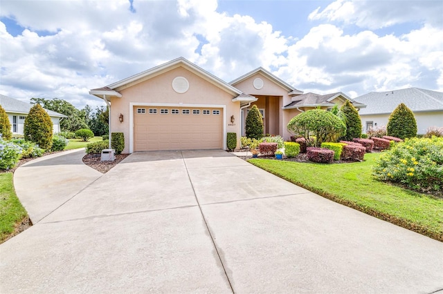 view of front of property with a garage and a front yard