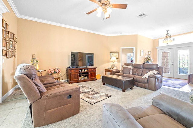 tiled living room with crown molding, ceiling fan, and french doors