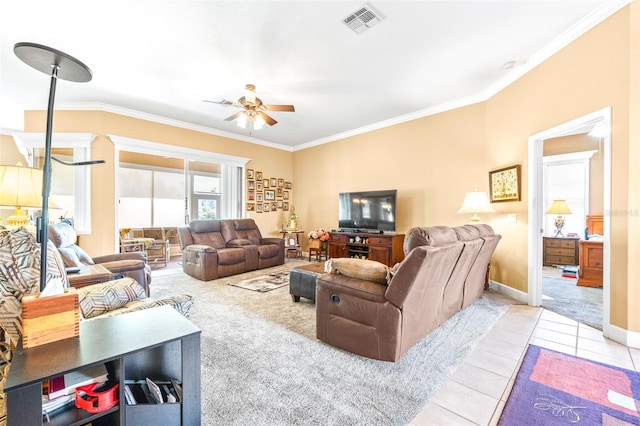 carpeted living room with ceiling fan and ornamental molding