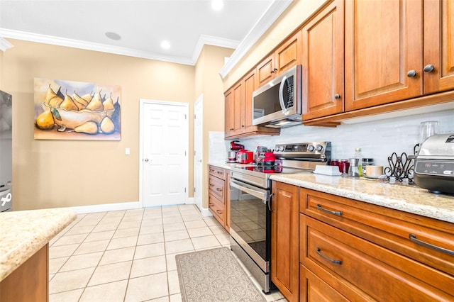 kitchen with decorative backsplash, stainless steel appliances, light tile patterned floors, ornamental molding, and light stone countertops