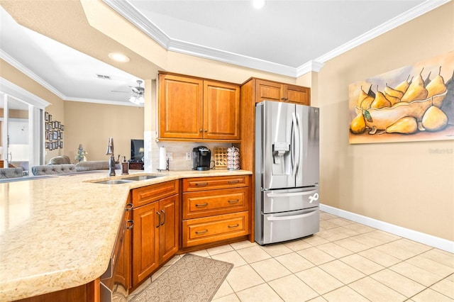 kitchen with ceiling fan, stainless steel fridge, sink, ornamental molding, and backsplash