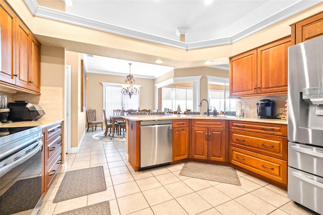 kitchen with appliances with stainless steel finishes, light tile patterned flooring, an inviting chandelier, ornamental molding, and sink