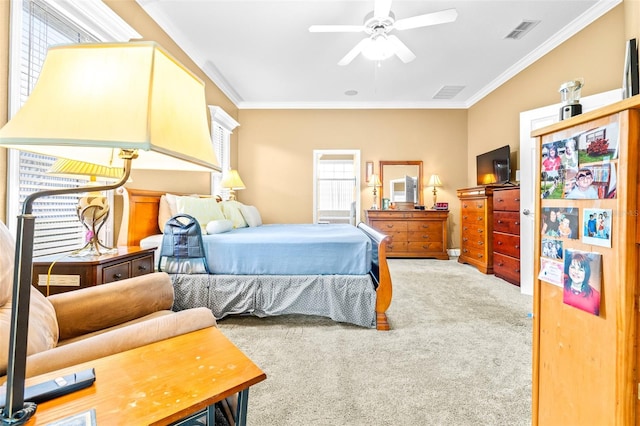 carpeted bedroom with ceiling fan and crown molding