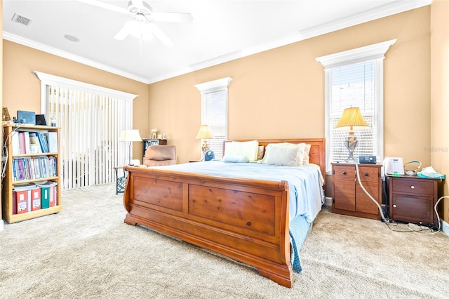 carpeted bedroom with crown molding and ceiling fan