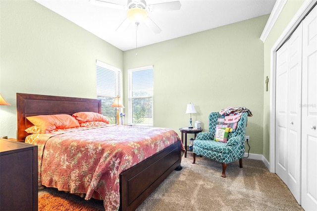 carpeted bedroom featuring ceiling fan and a closet