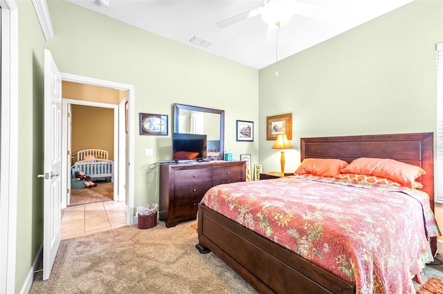 bedroom with light carpet and ceiling fan