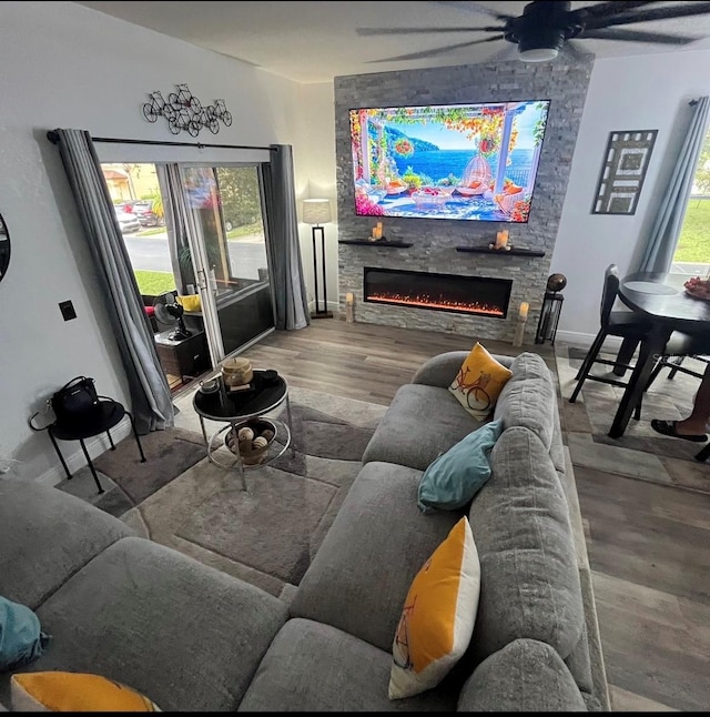 living room with a fireplace, hardwood / wood-style flooring, and ceiling fan