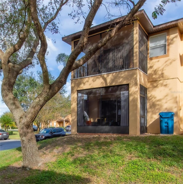 view of property exterior featuring a lawn