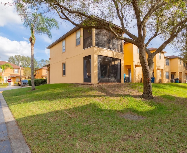 back of property featuring a lawn