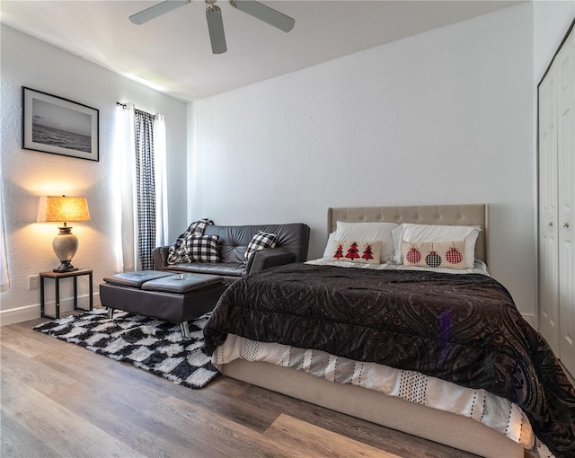 bedroom featuring a closet, wood-type flooring, and ceiling fan