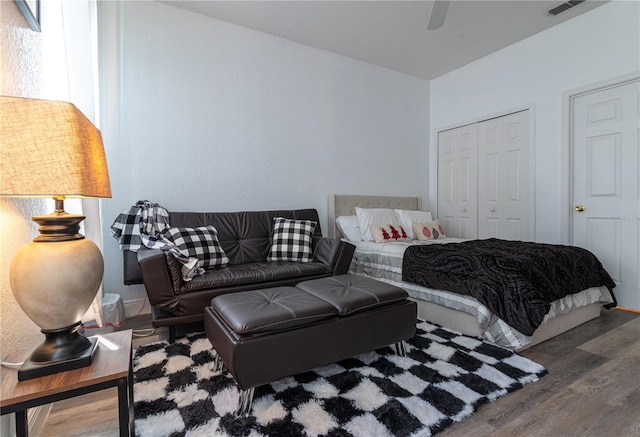 bedroom featuring ceiling fan, wood-type flooring, and a closet