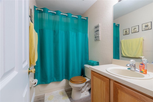 full bathroom with vanity, hardwood / wood-style flooring, toilet, and shower / bathtub combination with curtain