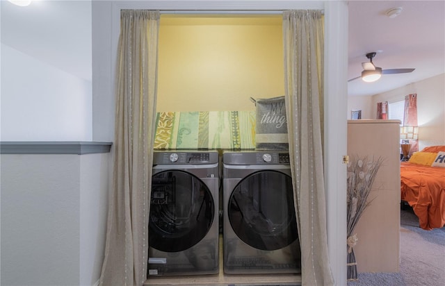 laundry area with ceiling fan, washer and dryer, and carpet floors