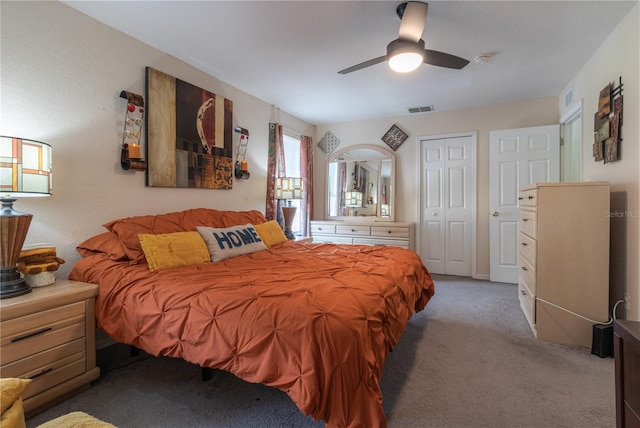 carpeted bedroom featuring a closet and ceiling fan