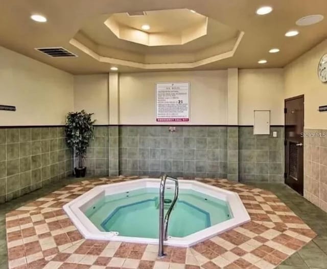 view of pool with an indoor hot tub