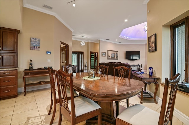 dining room featuring track lighting, an inviting chandelier, ornamental molding, and light tile patterned flooring