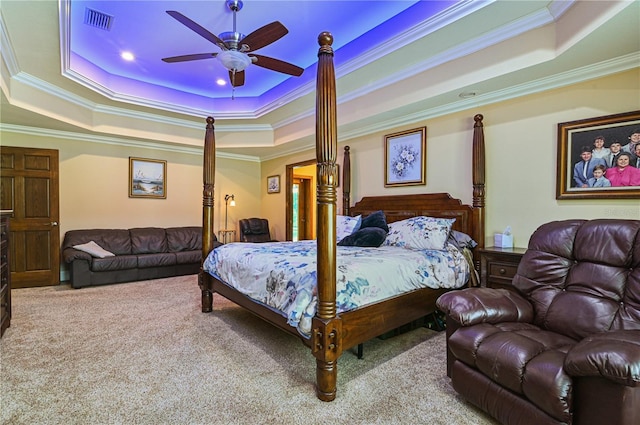 carpeted bedroom featuring ceiling fan, a raised ceiling, and ornamental molding