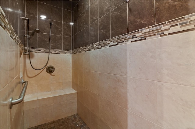 bathroom with a tile shower