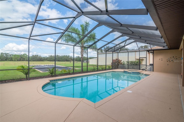 view of pool featuring an in ground hot tub, a patio, and glass enclosure