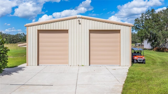 garage featuring a lawn