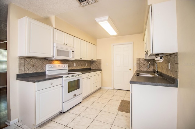 kitchen with sink, white cabinetry, white appliances, and tasteful backsplash