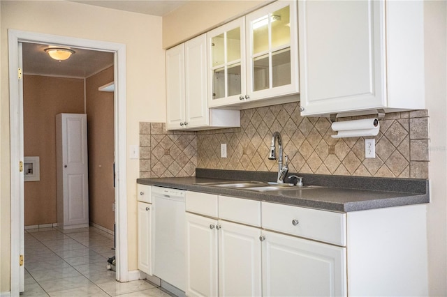 kitchen with white dishwasher, sink, white cabinetry, and decorative backsplash