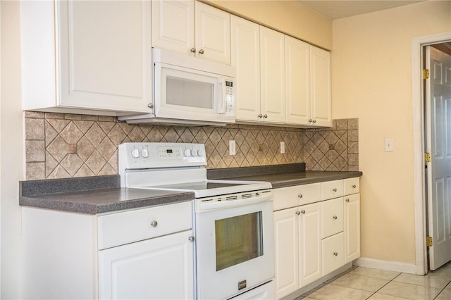 kitchen with white cabinetry, backsplash, and white appliances