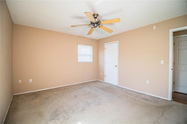 unfurnished bedroom with ceiling fan, light carpet, and a textured ceiling